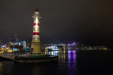 Famous white lighthouse in Malmo, Sweden near bridge at night