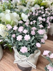artificial Gypsophila flowers in a ceramic pot with a ribbon for interior decoration