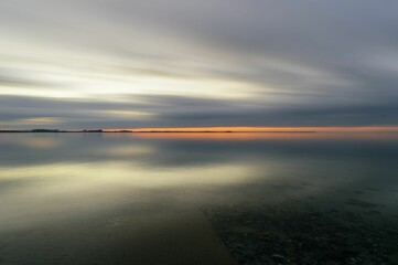 the sunset is almost beginning to set as seen from the shore
