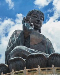 Low-angle shot of Tian Tan Buddha on Lantau Island in Hong Kong against a blue sky