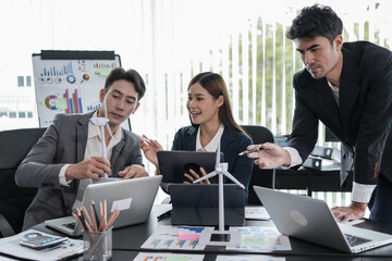 Asian business presents to explain the graph work on the whiteboard. Consulting, discussing, exchanging knowledge.