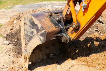 Excavator bucket during road and construction works.