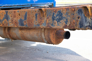 Rusty muffler and exhaust pipe of a truck.