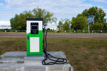 Electric vehicle charging station with power plug for electric vehicles. NFC payment. Smart energy. The concept of ecology and environmental pollution by car emissions.