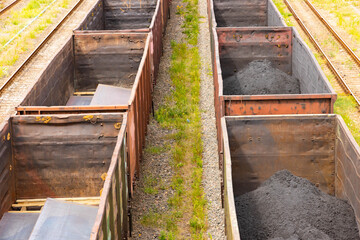 Tanks with fuel, wagons with cargo at a freight railway station. Logistics and transportation concept.