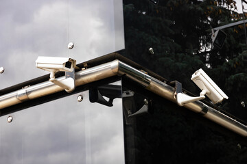 Security camera and city video, on the facade of an office building. Security and face recognition...