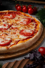 Tomato and cheese pizza with spiced tomatoes and cheese on a grey table