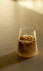 Glass of iced coffee in a minimalist coffee shop. Minimalist style.