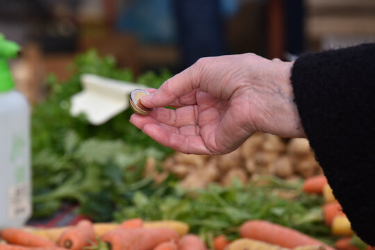 Zagreb, Croatia : 01, 05, 2024 : Close-up of paying  with euros at the vegetable market in Zagreb.