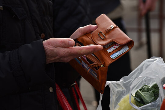 Zagreb, Croatia : 01, 05, 2024 : Close-up of paying  with euros at the vegetable market in Zagreb.