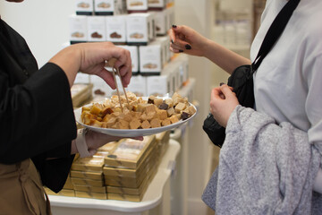 a person is serving different nougat choices