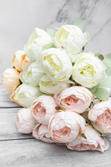 Artificial flowers for the interior closeup. Pink, white and orange peonies. Big bouquet
