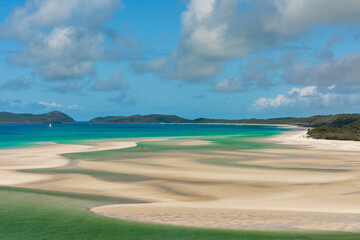 A beautiful beach with a green body of water in the background whitsunday
