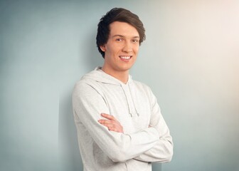 Handsome man standing on background crossed arms