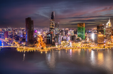 Fototapeta na wymiar Aerial panoramic cityscape view of HoChiMinh city and the River Saigon, Vietnam with blue sky at sunset. View from Thu Thiem peninsula