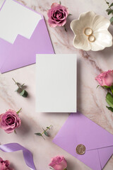 Wedding invitation card mockup, violet envelopes, gold rings, roses flowers on marble background. Flat lay, top view, copy space.