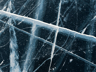 Aerial top down view on the blue cracked ice of the lake Baikal. Winter landscape, frozen lake. Ice...