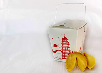 Classic Chinese food box with two fortune cookies on a white background with copy space