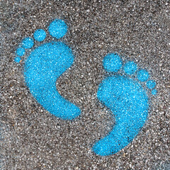 Blue footprint signs on an asphalt