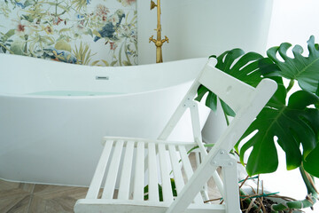 White bathroom with empty white chair, copy space for bath products and cosmetics