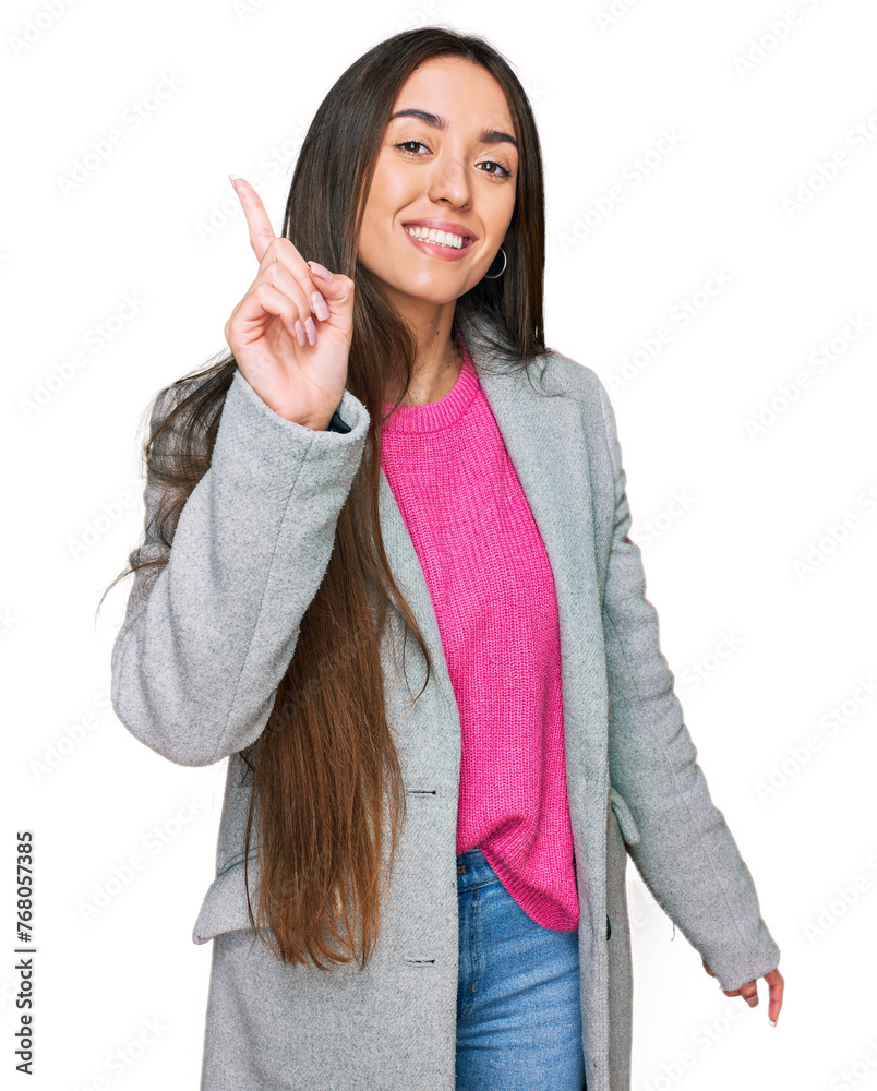 Wall mural Young hispanic girl wearing business clothes showing and pointing up with finger number one while smiling confident and happy.