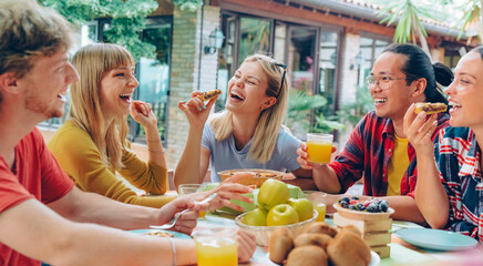 Happy young people eating healthy food at farm house picnic - Life style concept with cheerful woman and man drinking fresh orange juice sitting at cafe bar table - Food and beverage - 768058332