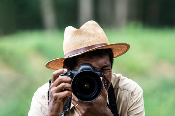 Capturing the wild’s essence, a photographer with focused intent. In the wild's gaze, a dedicated photographer seeks the perfect shot. Harmony between man and nature through the camera’s eye.