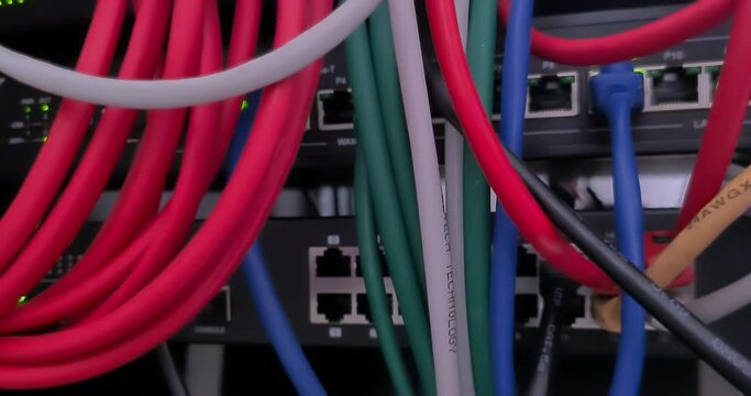 camera movement on colored cables and ethernet connections on servers and switches in a data center, concept of cybersecurity and corporate security from hacker attacks