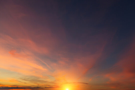 Epic Dramatic sunrise, sunset sky with cirrus clouds and yellow  orsnge sun and sunlight abstract background texture