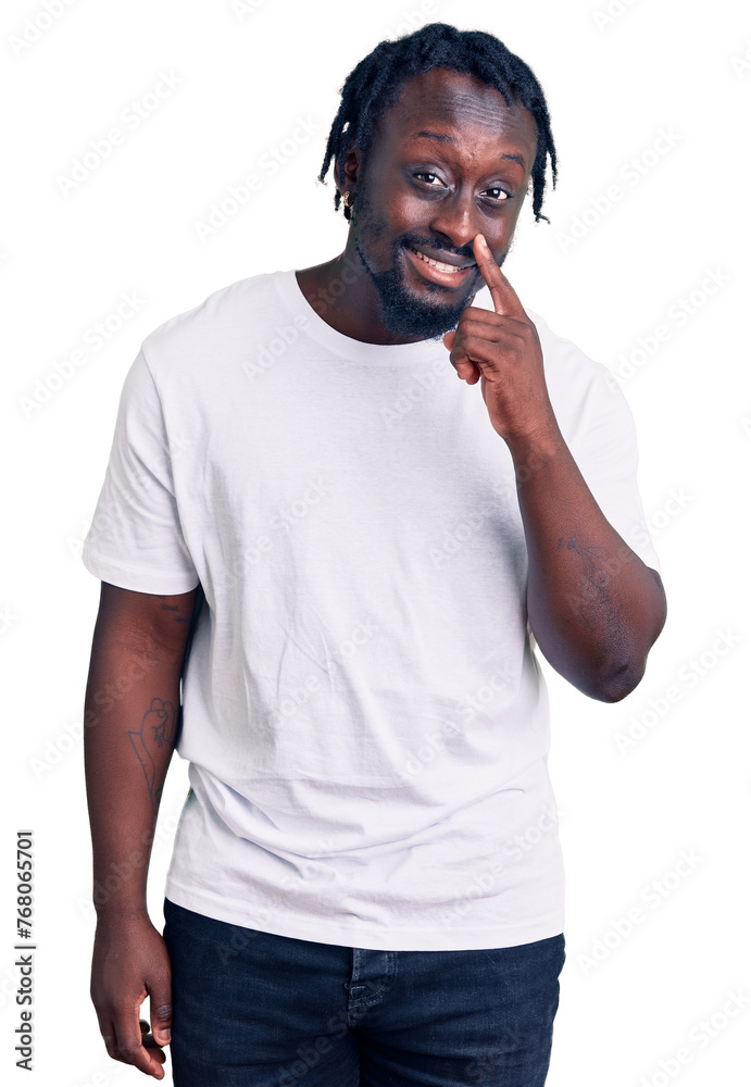 Canvas Prints Young african american man with braids wearing casual white tshirt pointing with hand finger to face and nose, smiling cheerful. beauty concept