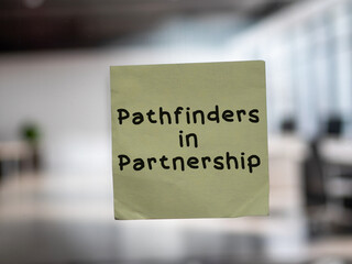Post note on glass with 'Pathfinders in Partnership'.