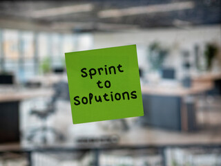 Post note on glass with 'Sprint to Solutions'.