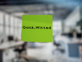Post note on glass with 'Quick-Witted'.