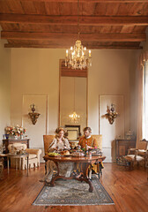 Noble, couple and luxury with food, dinner and renaissance home or house and dining table. King,...