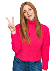 Young irish woman wearing casual clothes showing and pointing up with fingers number two while smiling confident and happy.