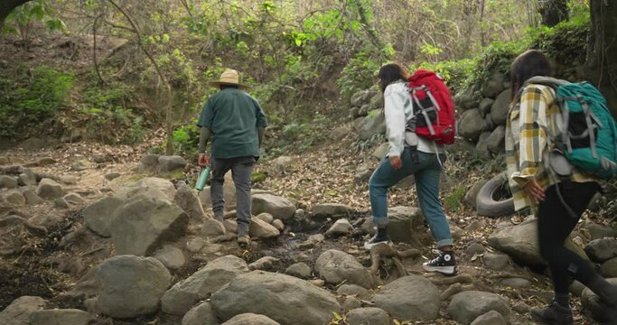 Small group following a guide in real mexican tour in San Jeronimo Tecuanipan