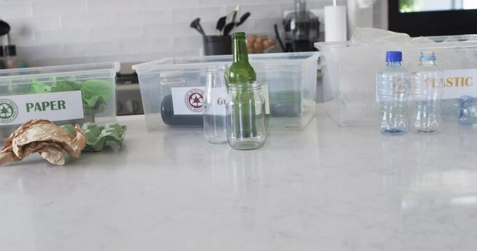 Various recyclables are sorted on a kitchen counter