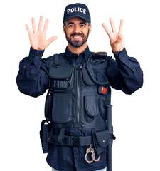 Young hispanic man wearing police uniform showing and pointing up with fingers number eight while smiling confident and happy.