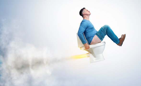 A funny man in casual clothes flies up sitting on the toilet leaving exhaust and smoke in his wake. On light background.