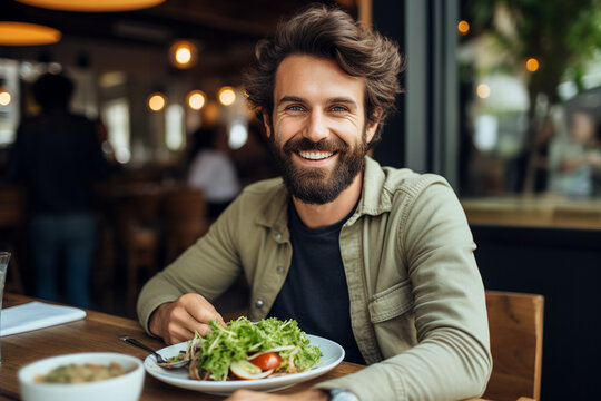 Generated with AI picture of handsome cheerful man in cafe eating tasty vegetables salad