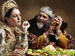 King, queen and royalty with feast and wine in banquet hall for fine dinning for tradition or...
