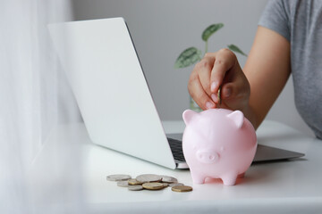 Woman hand putting coin into a piggy bank, Retirement planning, Health insurance, Money saving,...