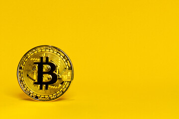 a physical bitcoin cryptocurrency with space for text on a yellow background,web3 concept and blockchain technology