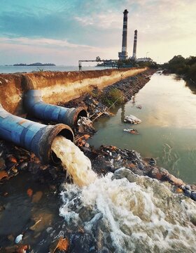 Environmental damage concept, Industrial and factory wastewater discharge pipe into the canal and sea, dirty water pollution, Sewage pipe outfall into the river, the river is polluted