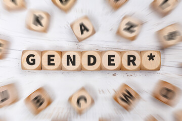 Gendern mit Gendersternchen als Symbol für gendergerechte Sprache auf Würfeln Kommunikation Konzept - obrazy, fototapety, plakaty