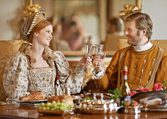 Royal, king and queen in renaissance with luxury, wine and happiness with toast together for wedding night. Noble, man and woman with smile for wealth in marriage and girl with husband in palace