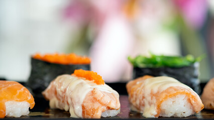 Delectable highlighted Sushi Set with Creamy Toppings on Tray with a soft-focus background enhancing the vibrant colors