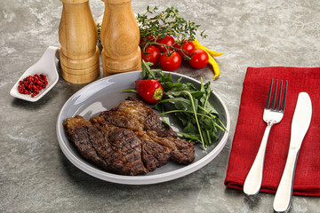 Grilled chuck roll steak with arugula