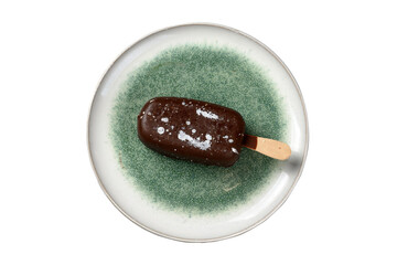 chocolate ice cream ice cream on a stick in a plate, cut out, top view