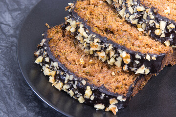 Pastry made of zucchini with nuts and raisin on plate. Delicious dessert